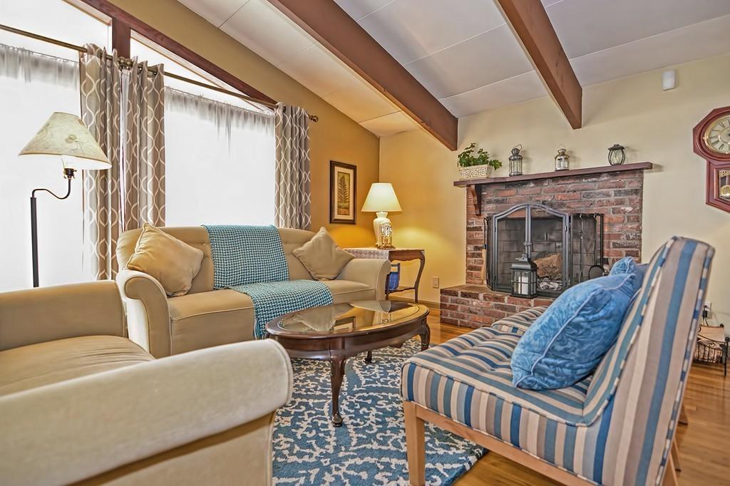 45 Walnut Street Millis, MA 02054 - Photo 2 of 32 a living room with furniture a fireplace and a floor to ceiling window
