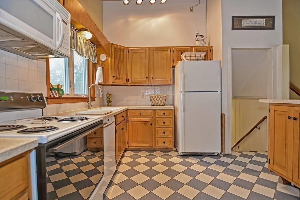 45 Walnut Street Millis, MA 02054 - Photo 9 of 32 a kitchen with a stove a sink and a refrigerator