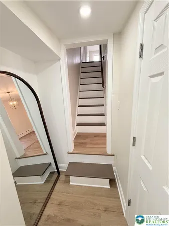 a bathroom with a tub a sink and mirror