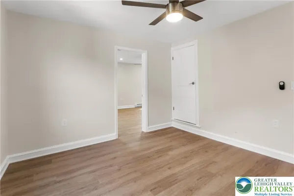 a view of a livingroom with a window and wooden floor