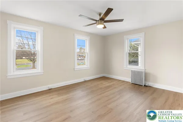 a view of a small space with wooden floor and a window