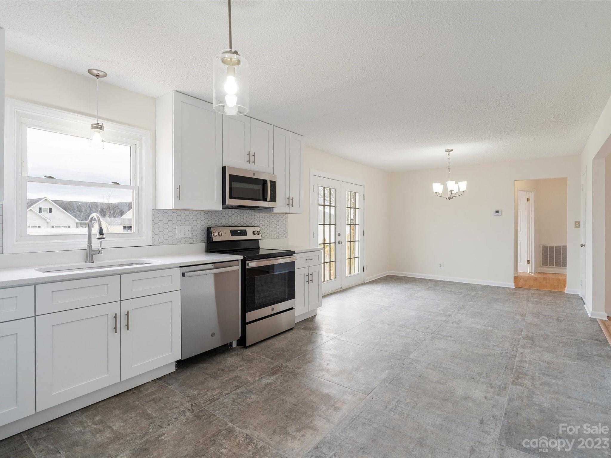158 Baxter Road Cherryville, NC 28021 - Photo 11 of 38 a kitchen with granite countertop a sink cabinets and stainless steel appliances