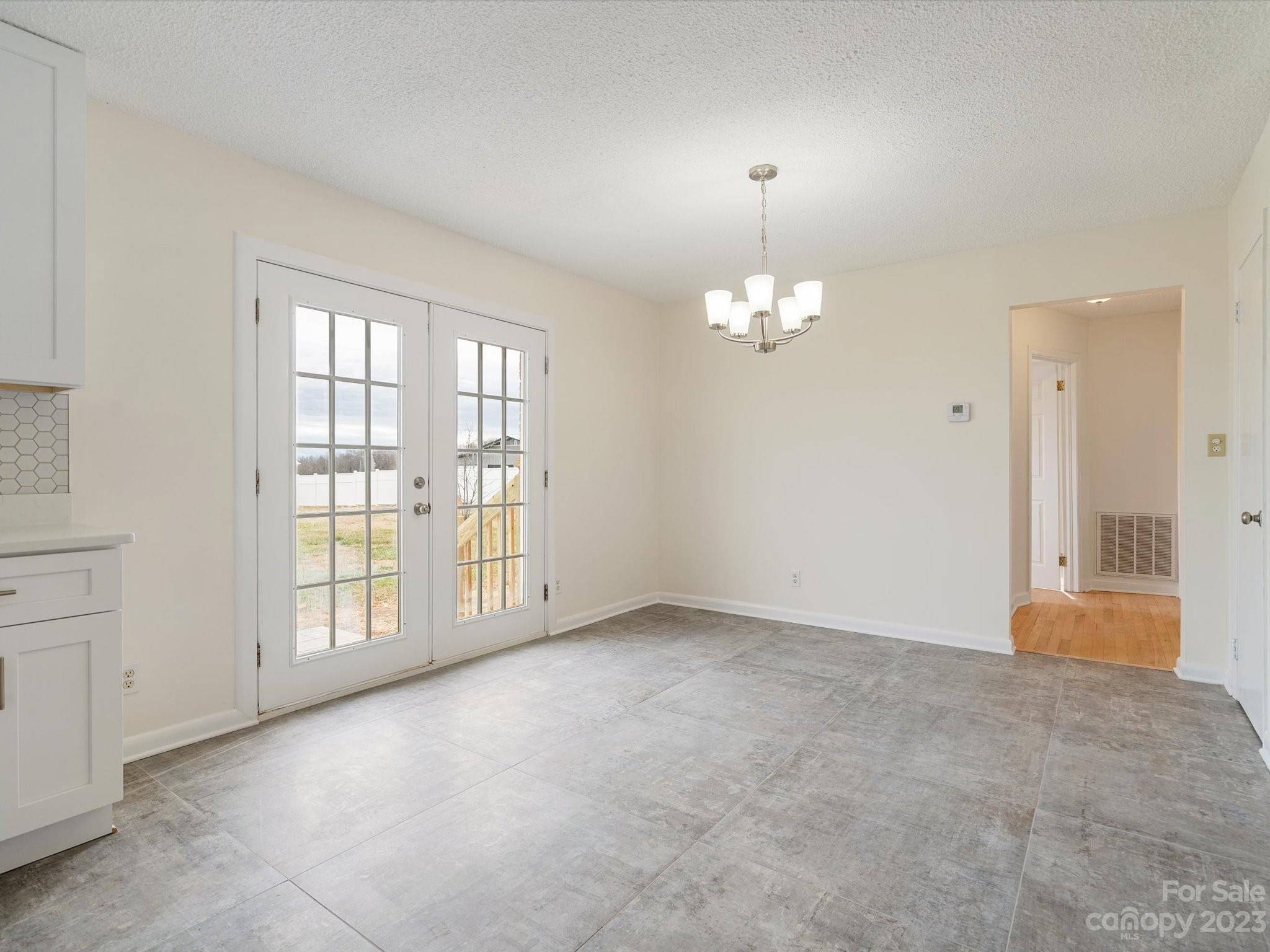 158 Baxter Road Cherryville, NC 28021 - Photo 13 of 38 an empty room with chandelier and windows