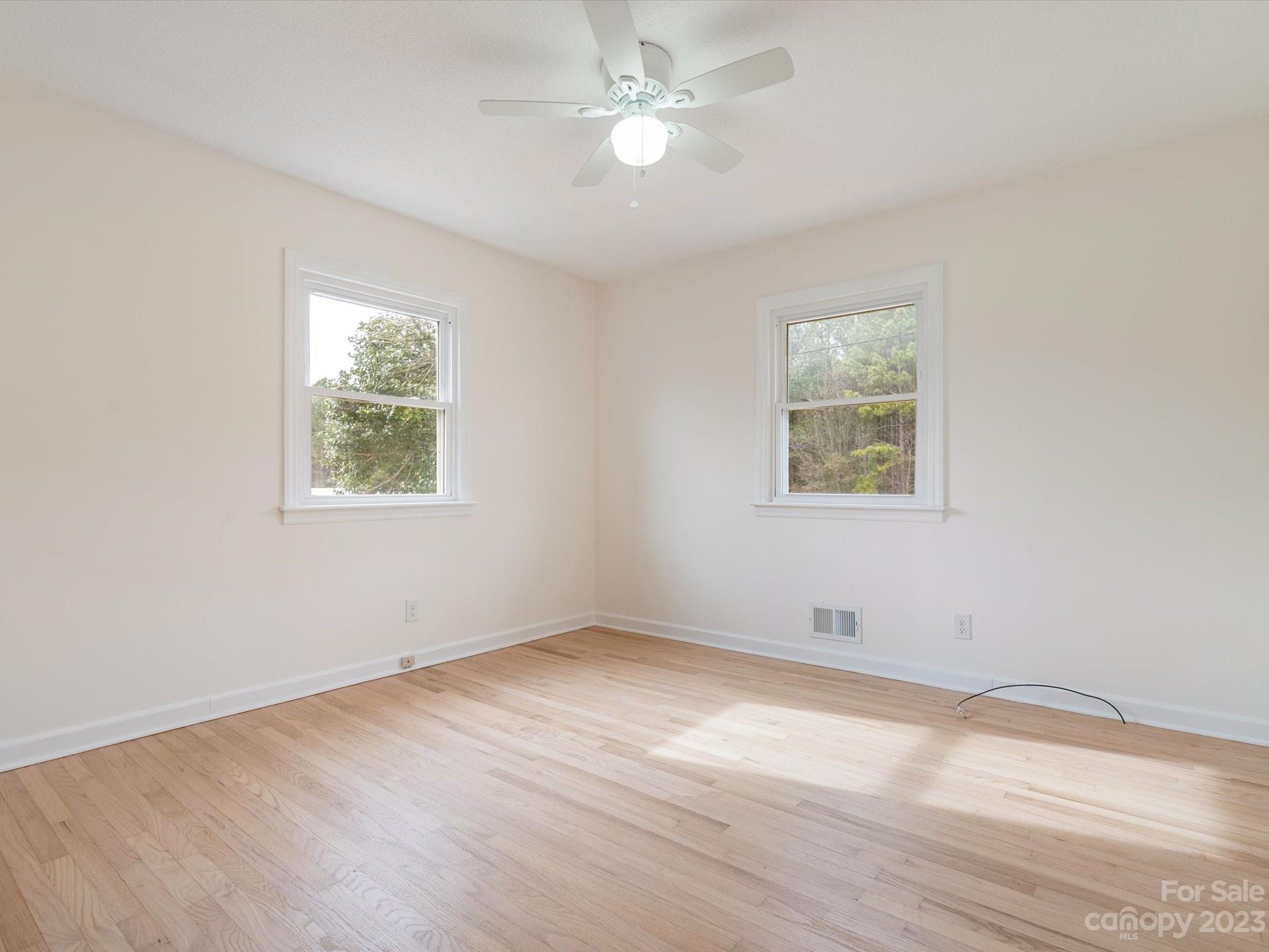 158 Baxter Road Cherryville, NC 28021 - Photo 24 of 38 an empty room with wooden floor and windows