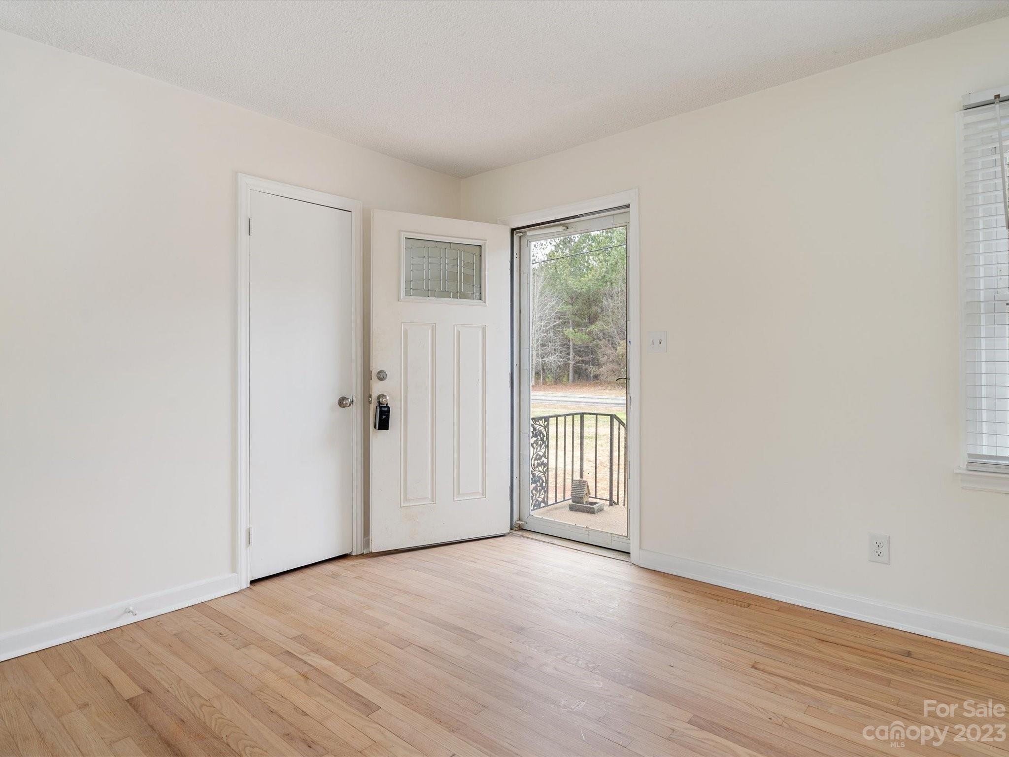 158 Baxter Road Cherryville, NC 28021 - Photo 3 of 38 a view of an empty room with wooden floor and a window