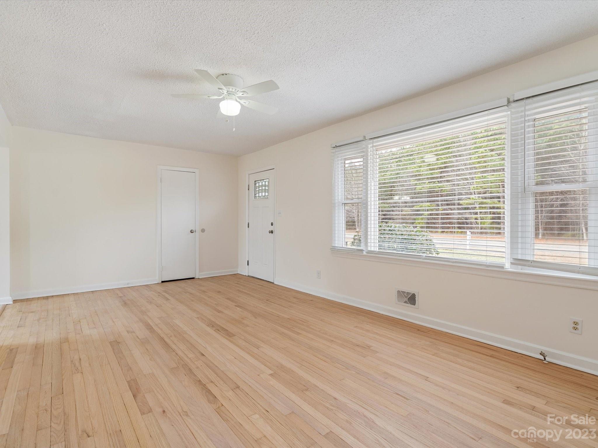 158 Baxter Road Cherryville, NC 28021 - Photo 4 of 38 a view of an empty room with wooden floor and a window