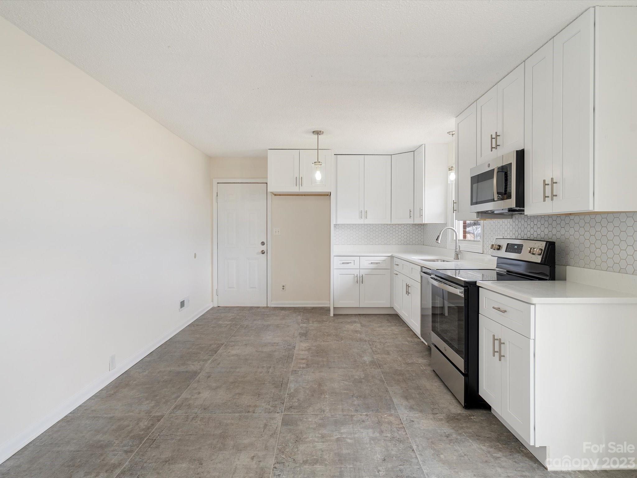 158 Baxter Road Cherryville, NC 28021 - Photo 8 of 38 a kitchen with cabinets stainless steel appliances and sink