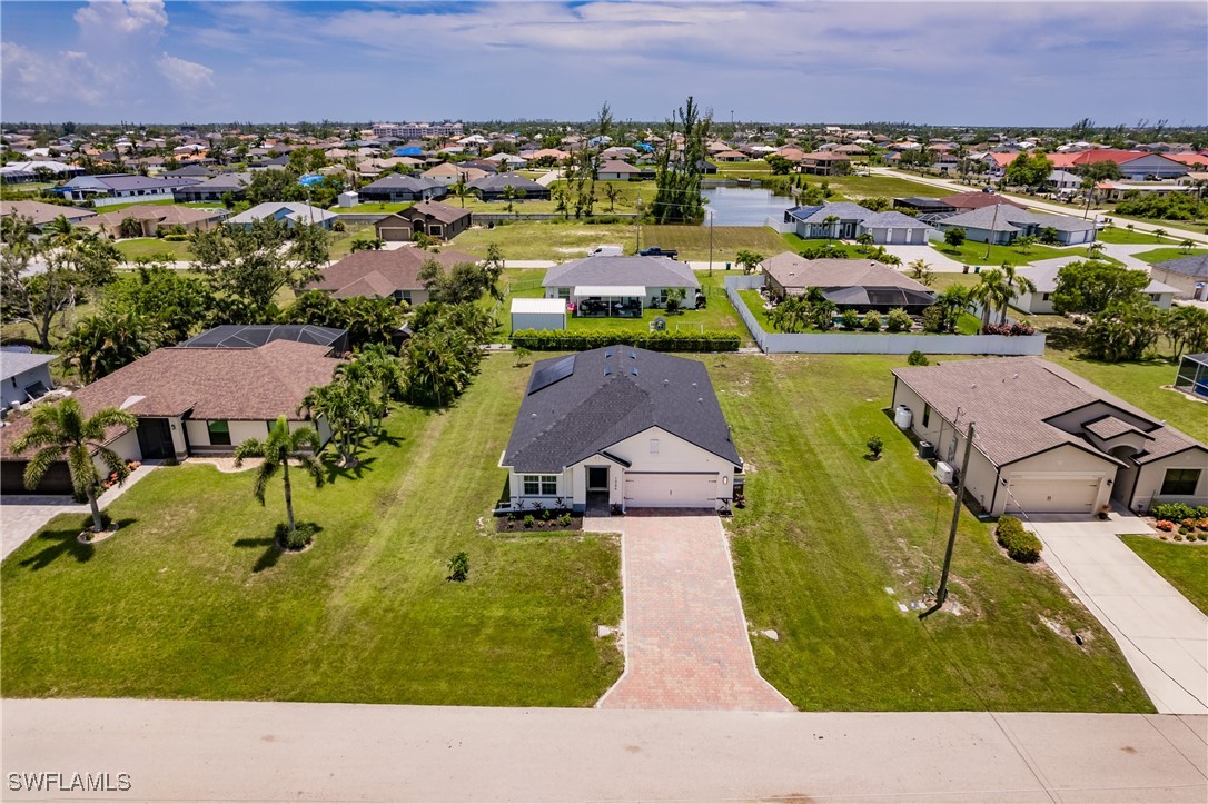 an aerial view of a house with a swimming pool yard and outdoor seating