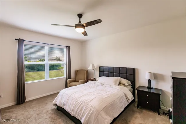 a bedroom with a large bed and a large window