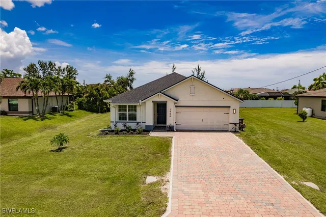 a front view of house with yard and swimming pool
