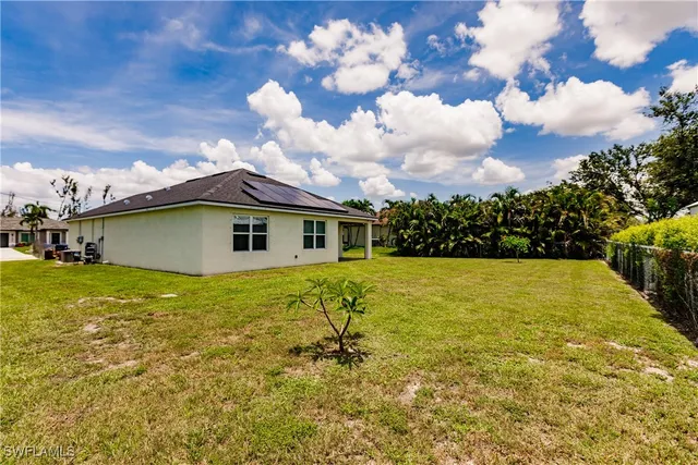 a yellow house with garden in front of it