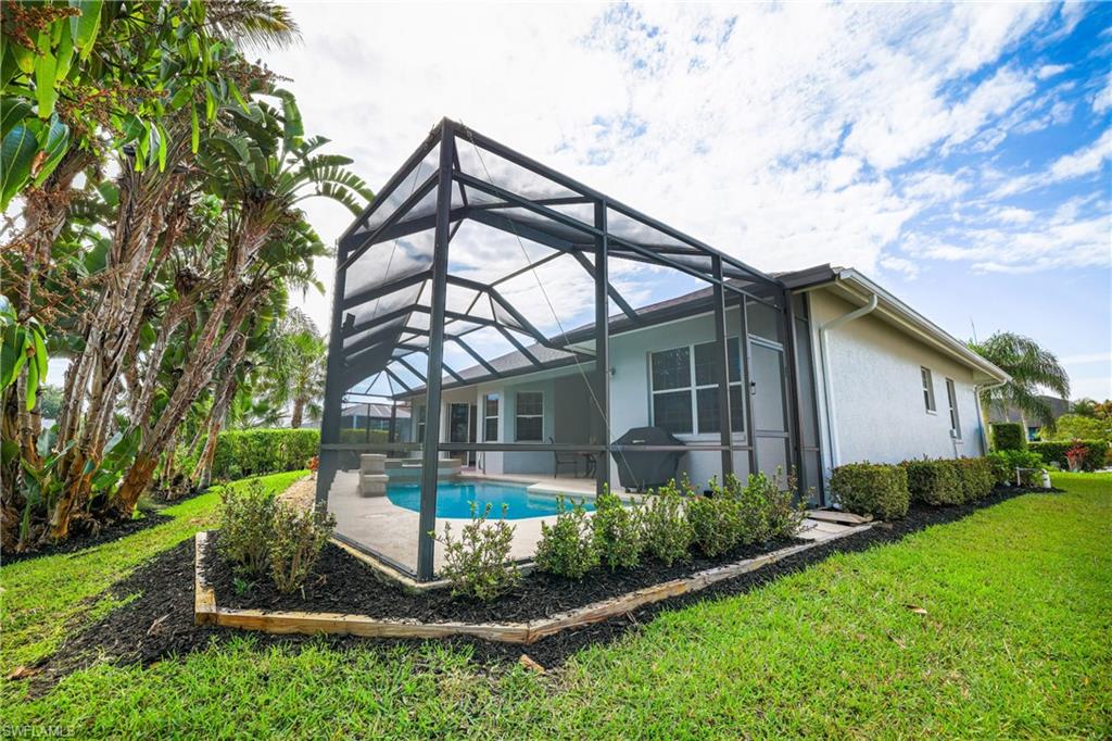 5235 Malvern Court Naples, FL 34112 - Photo 27 of 28 a front view of a house with garden