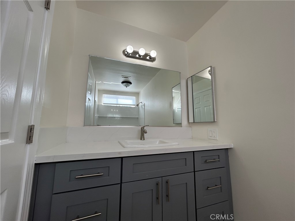 9079 Colony Place Riverside, CA 92503 - Photo 13 of 21 a bathroom with a double vanity sink and a mirror