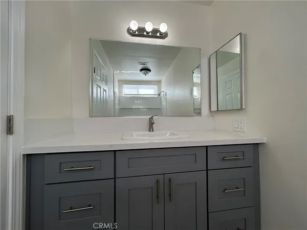 a bathroom with a double vanity sink and a mirror