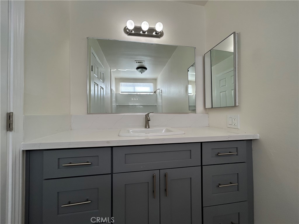 9079 Colony Place Riverside, CA 92503 - Photo 14 of 21 a bathroom with a double vanity sink and a mirror