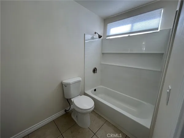 a bathroom with a toilet and shower