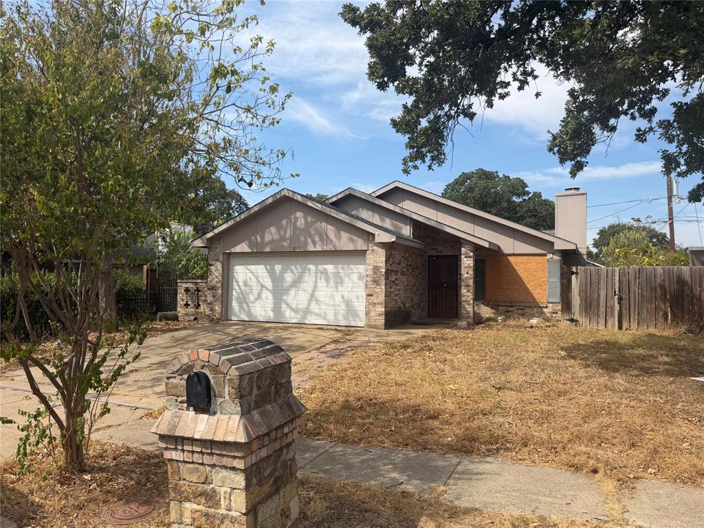 10823 Addie Road Dallas, TX 75217 - Photo 1 of 20 Stone and brick facade with a two-car garage
