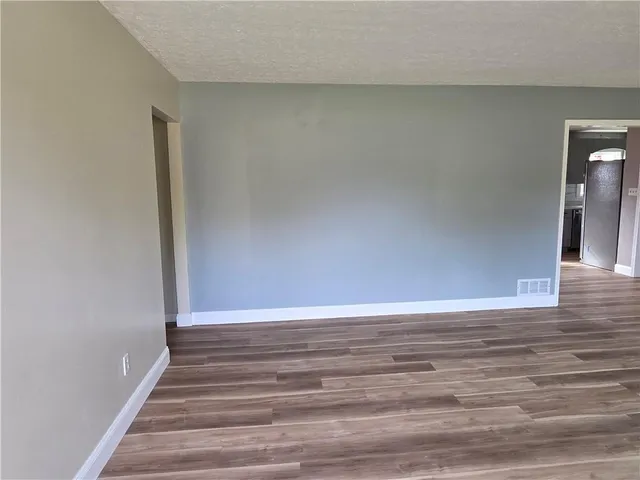 a view of an empty room and wooden floor