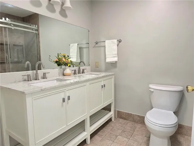 a bathroom with a sink toilet and mirror