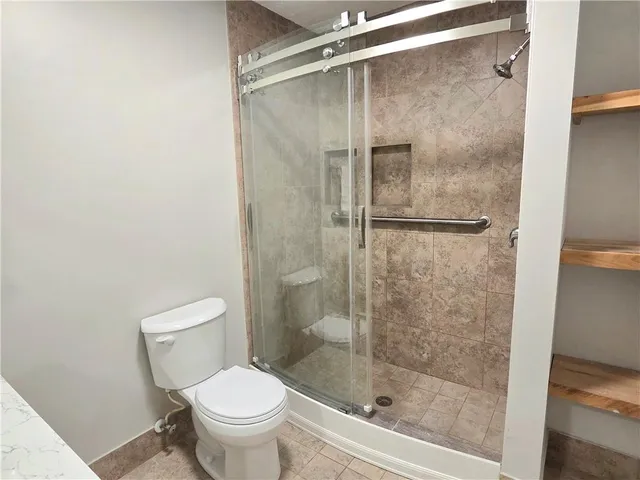 a bathroom with a shower and a toilet