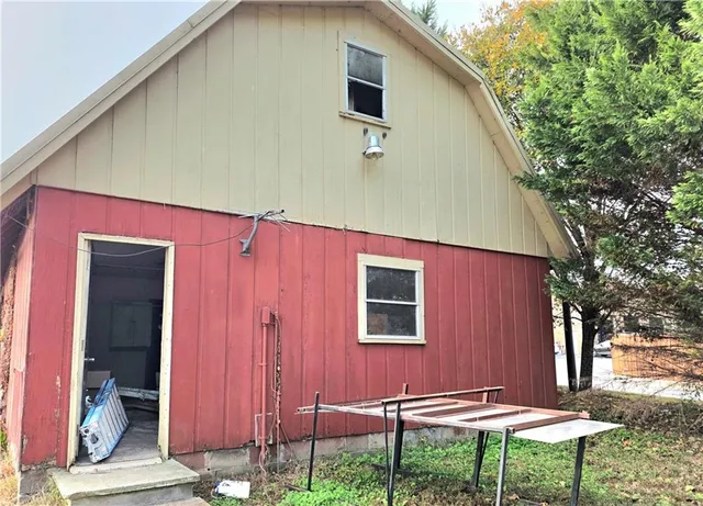 a backyard of a house with table and chairs