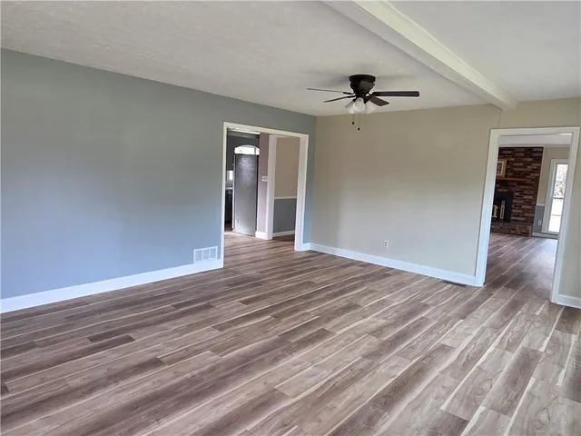 wooden floor in an empty room with a window