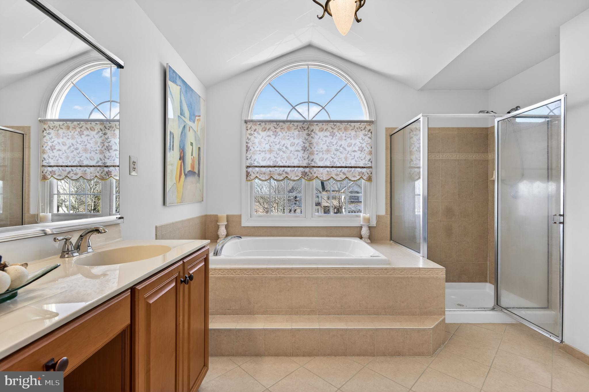 98 Granville Way Exton, PA 19341 - Photo 25 of 35 a spacious bathroom with a granite countertop tub a sink and a large window
