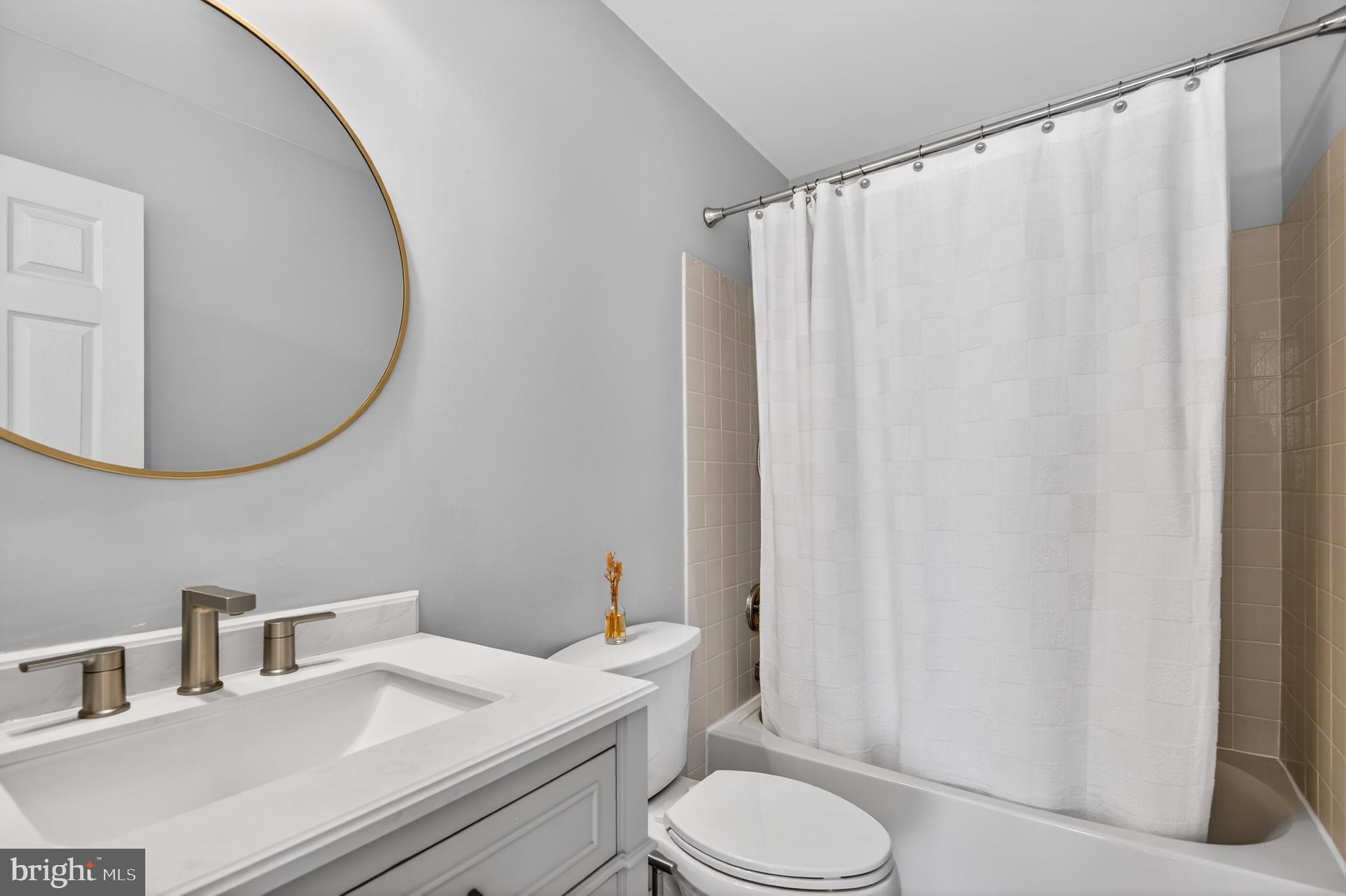 98 Granville Way Exton, PA 19341 - Photo 31 of 35 a bathroom with a sink a toilet and shower curtain