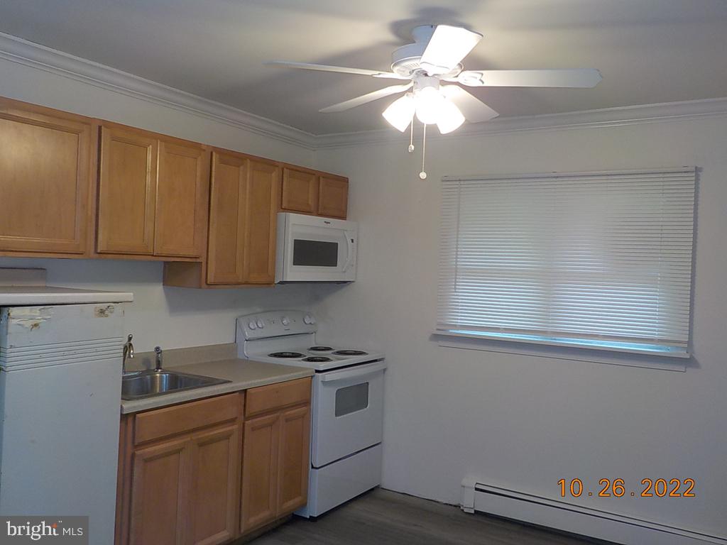 1109 Montgomery Road Wilmington, DE 19805 - Photo 4 of 11 a kitchen with cabinets appliances and a window