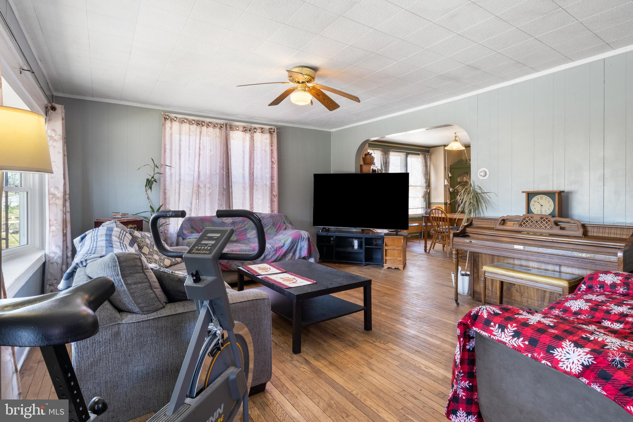 31 West Hanover Street Spring Grove, PA 17362 - Photo 6 of 31 a living room with furniture a flat screen tv and a floor to ceiling window