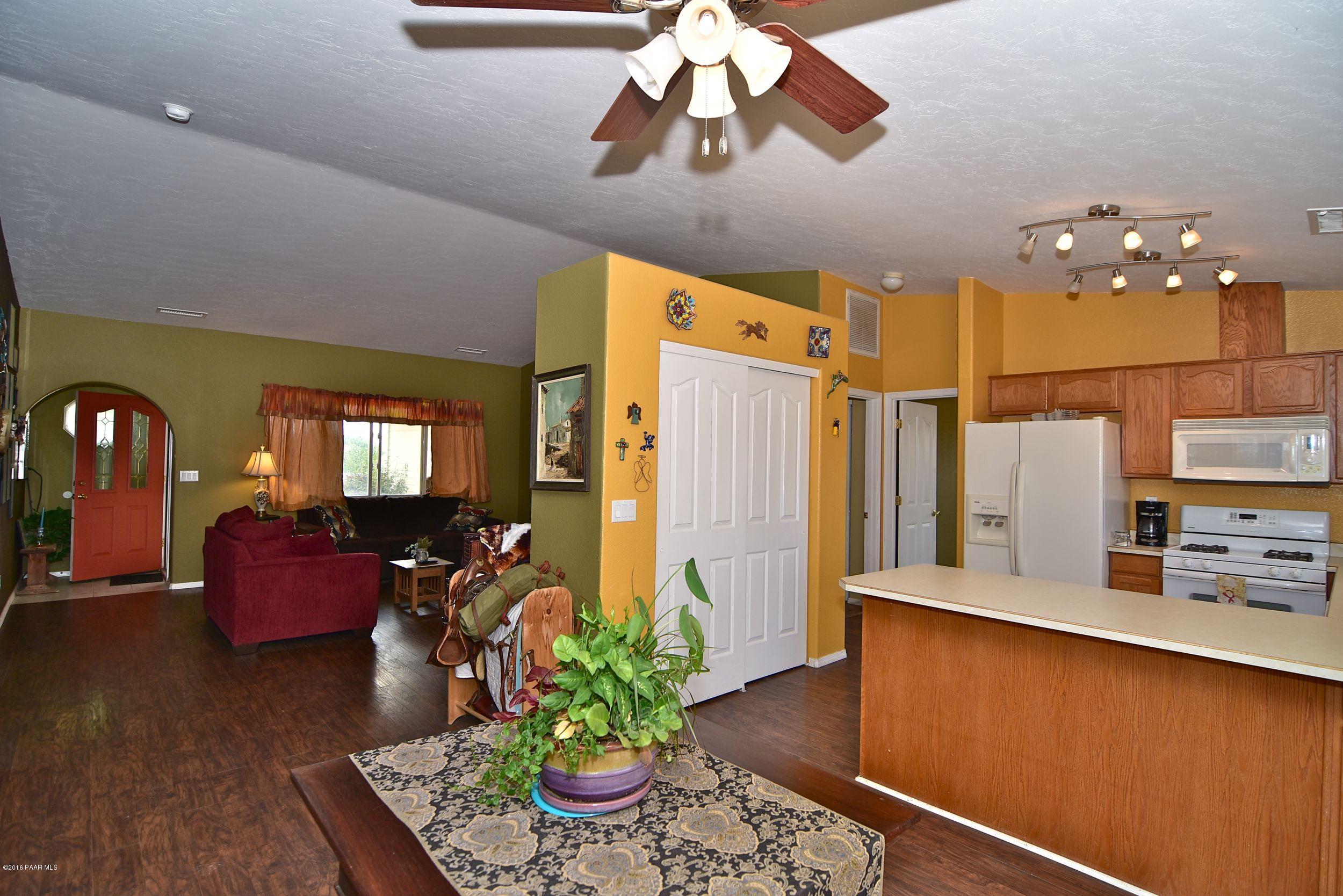 2200 West Lazy Ranch Road Chino Valley, AZ 86323 - Photo 15 of 32 a dining room with stainless steel appliances furniture a chandelier and a view of kitchen