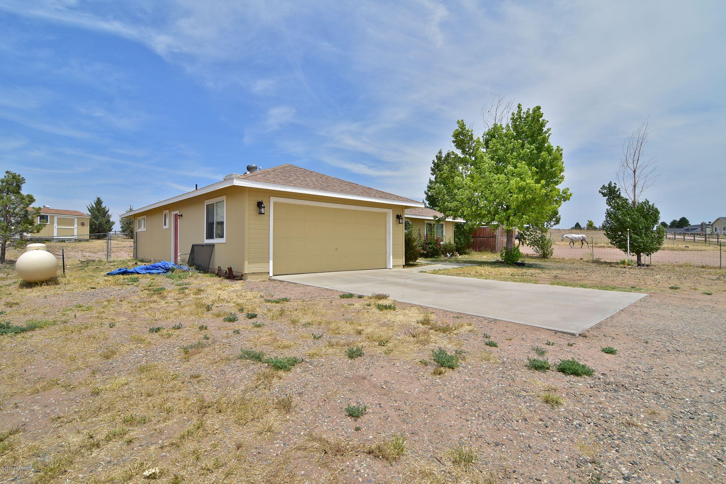 2200 West Lazy Ranch Road Chino Valley, AZ 86323 - Photo 2 of 32 a front view of a house with a tree
