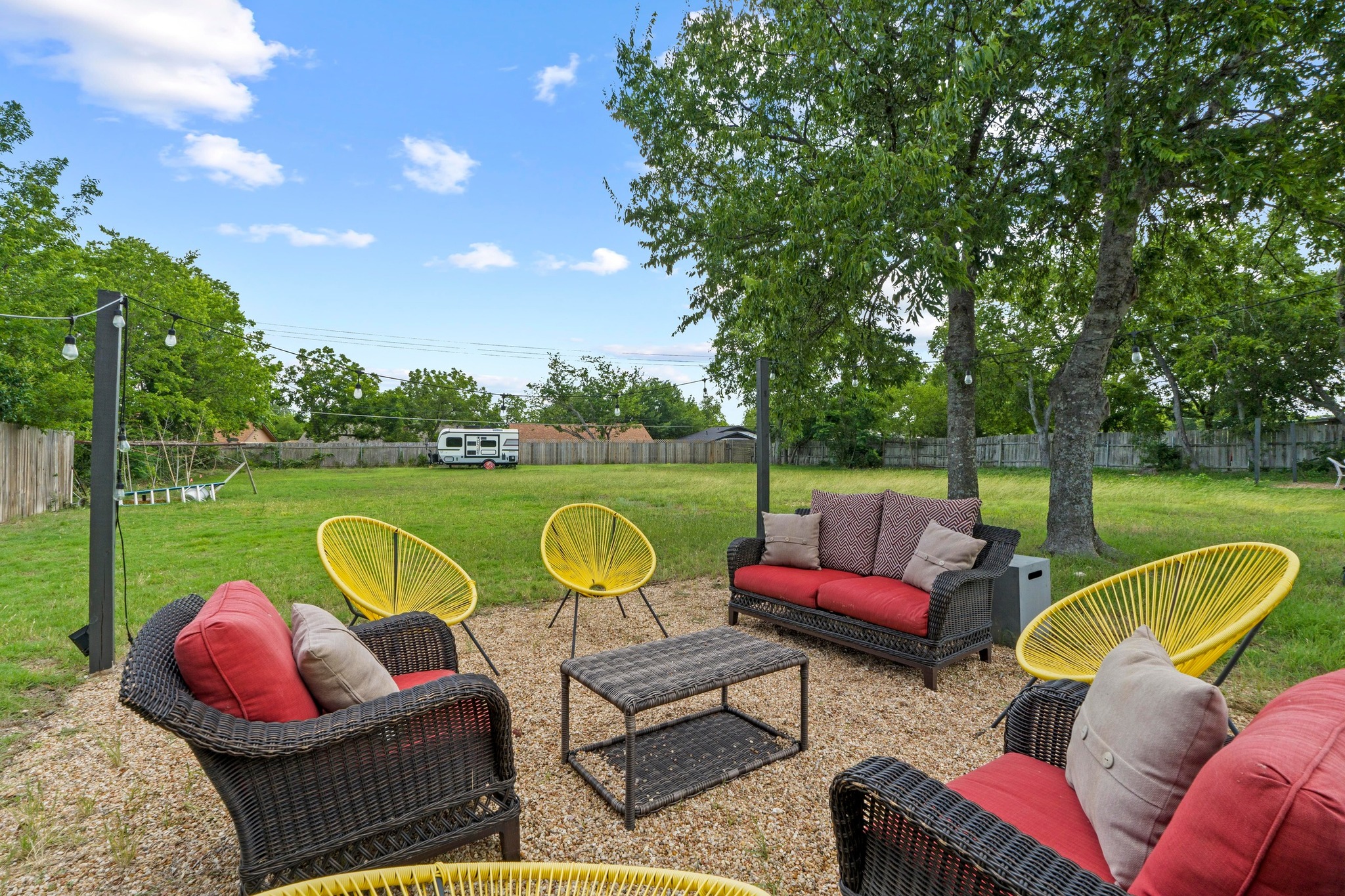 10601 Macmora Road, Unit B Austin, TX 78758 - Photo 21 of 22 A spacious backyard patio area with outdoor seating and ample green space for leisure activities.