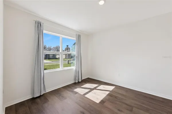 a bathroom with a granite countertop sink toilet mirror and shower