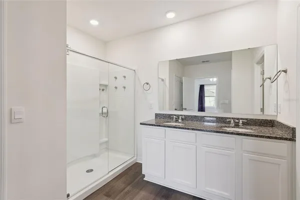 a bathroom with a granite countertop sink toilet and shower