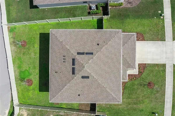 an aerial view of a city with lots of residential buildings and mountain view in back