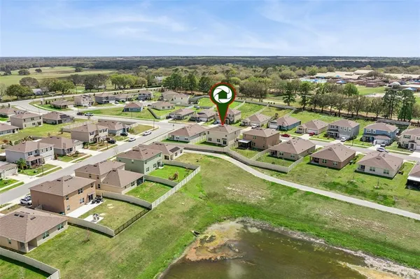 an aerial view of residential houses with outdoor space and river