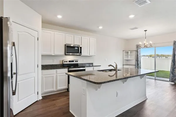 a kitchen with a sink a stove a refrigerator and a refrigerator