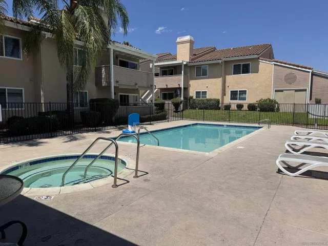 a view of a house with swimming pool in front of it