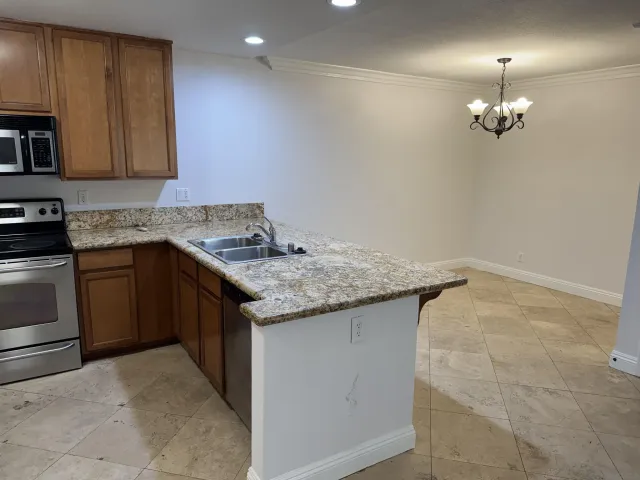 a kitchen that has a sink and a stove in it