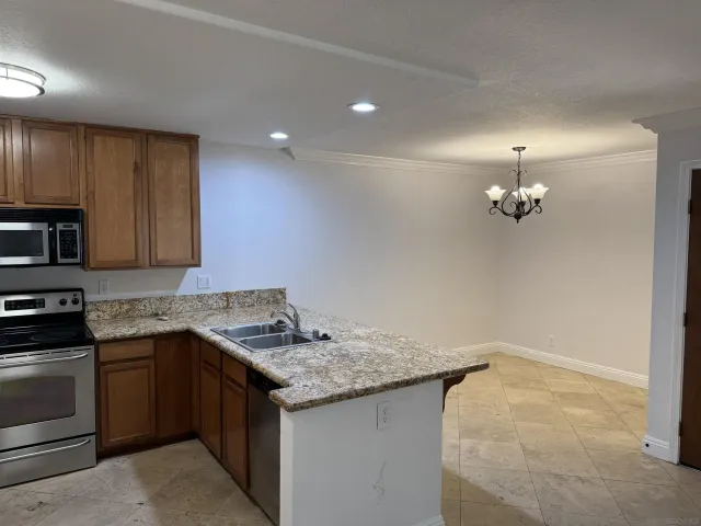 a kitchen with a sink vanity and stove