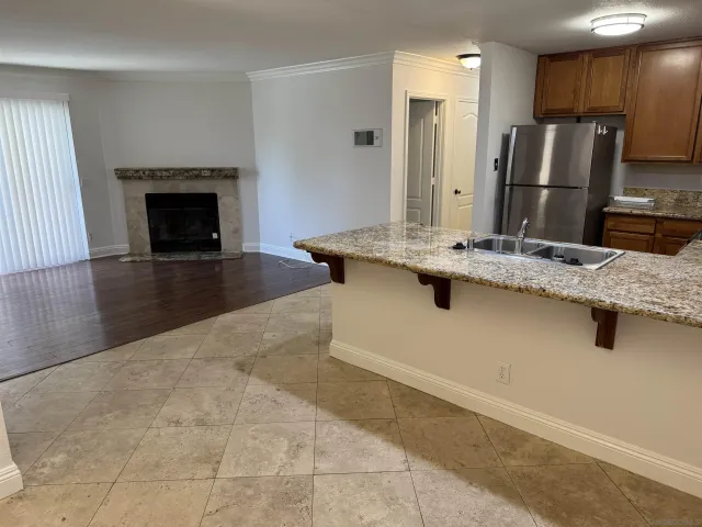 a kitchen with kitchen island a sink stainless steel appliances and a counter top space