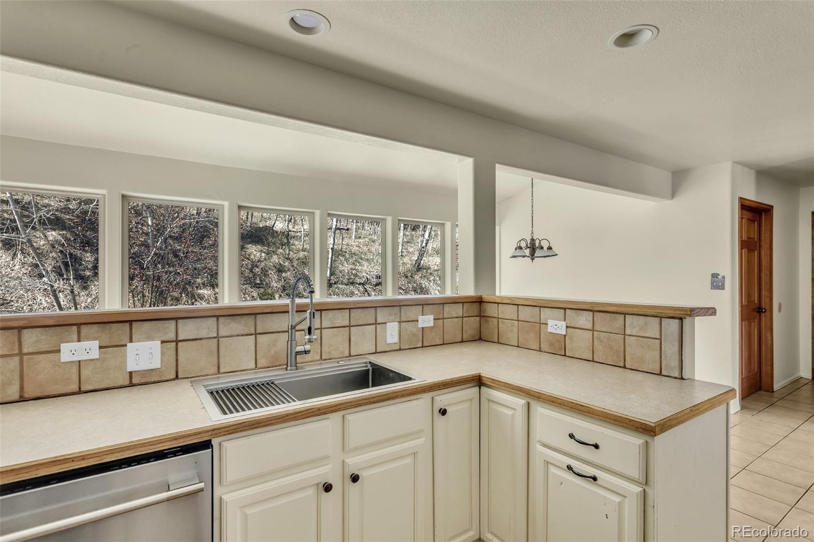 12183 Arnett Ranch Road Littleton, CO 80127 - Photo 10 of 28 a kitchen with a sink and cabinets