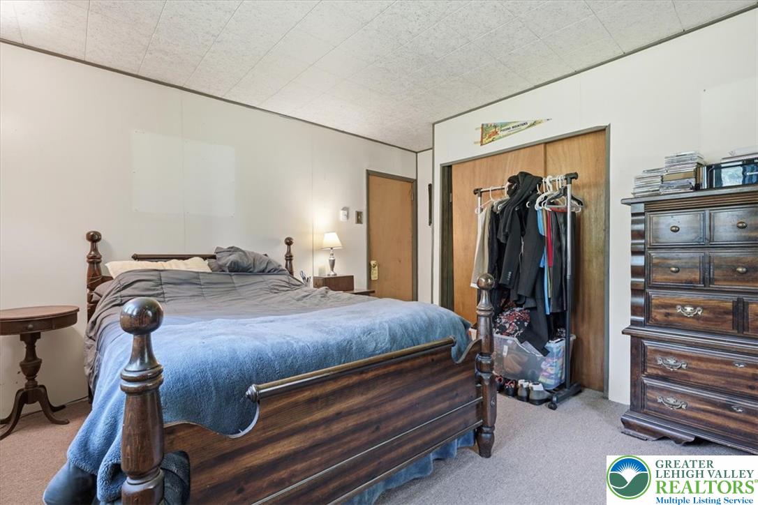 143 Logger Road Canadensis, PA 18325 - Photo 18 of 32 A well-lit sleeping chamber offers comfort and utility with convenient built-in storage solutions.