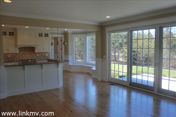 200 Katama Road Edgartown, MA 02539 - Photo 14 of 26 a view of a kitchen with a large window and wooden floor