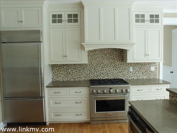 200 Katama Road Edgartown, MA 02539 - Photo 23 of 26 a kitchen with granite countertop white cabinets and stainless steel appliances