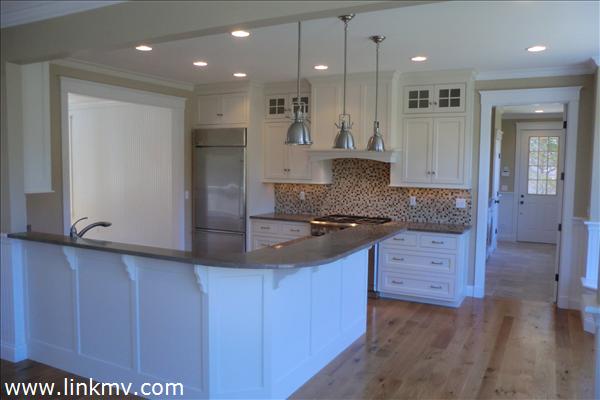 200 Katama Road Edgartown, MA 02539 - Photo 4 of 26 a large kitchen with granite countertop a sink and a refrigerator