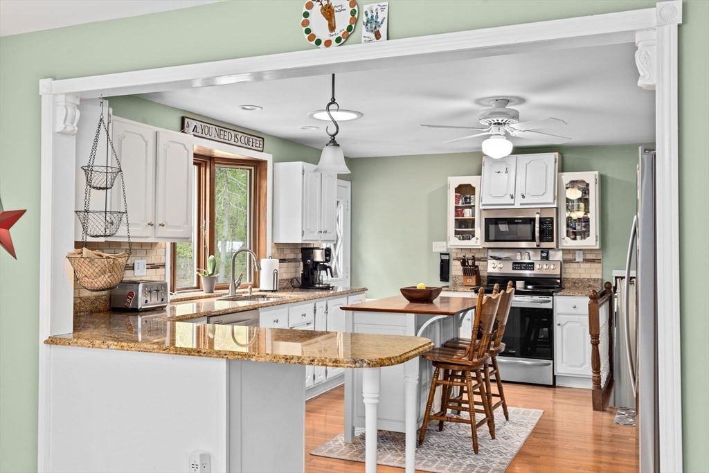 39 High Street Freetown, MA 02702 - Photo 14 of 42 a kitchen with stainless steel appliances kitchen island granite countertop a sink and cabinets