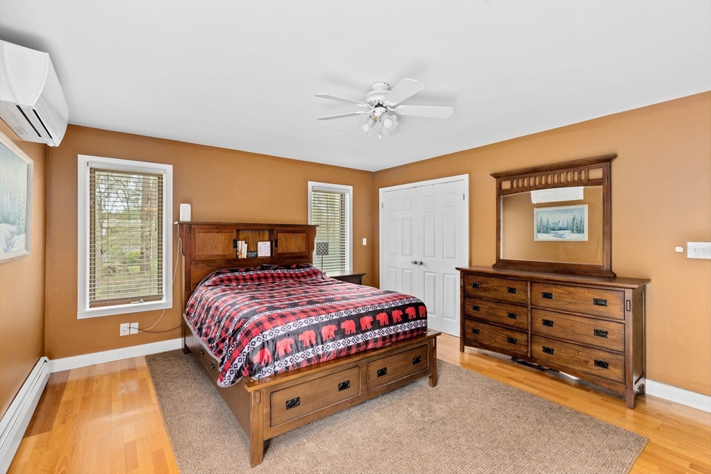 39 High Street Freetown, MA 02702 - Photo 17 of 42 a bedroom with a bed and a chandelier