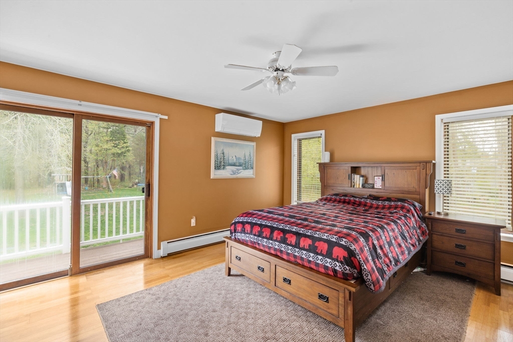 39 High Street Freetown, MA 02702 - Photo 18 of 42 a bedroom with a bed and a chandelier